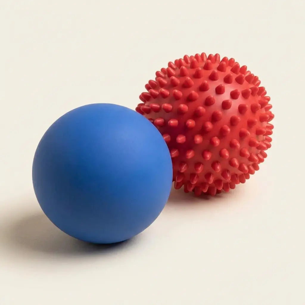 Blue lacrosse ball and red spiky massage ball